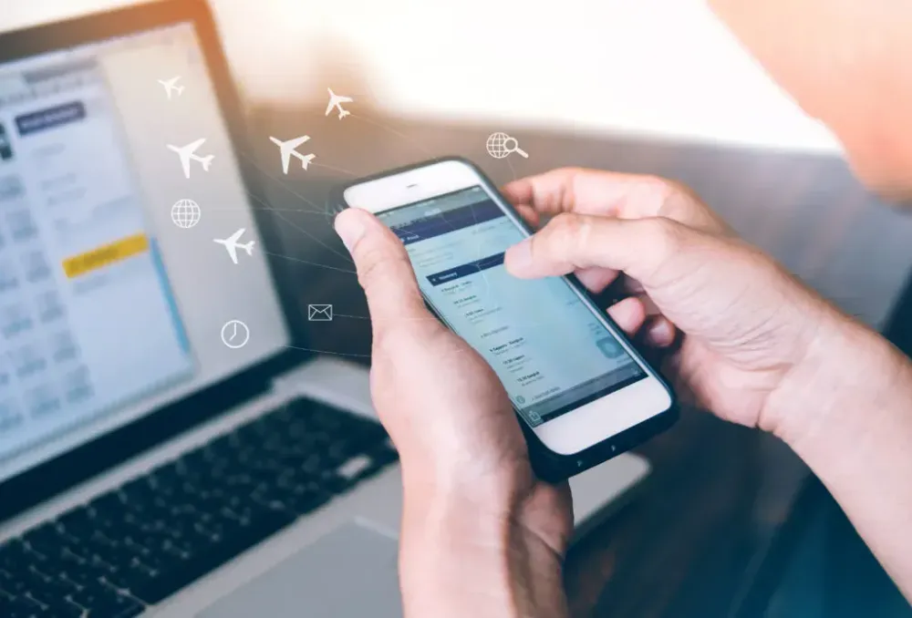 Person using phone with superimposed graphics of airplanes flying from the screen